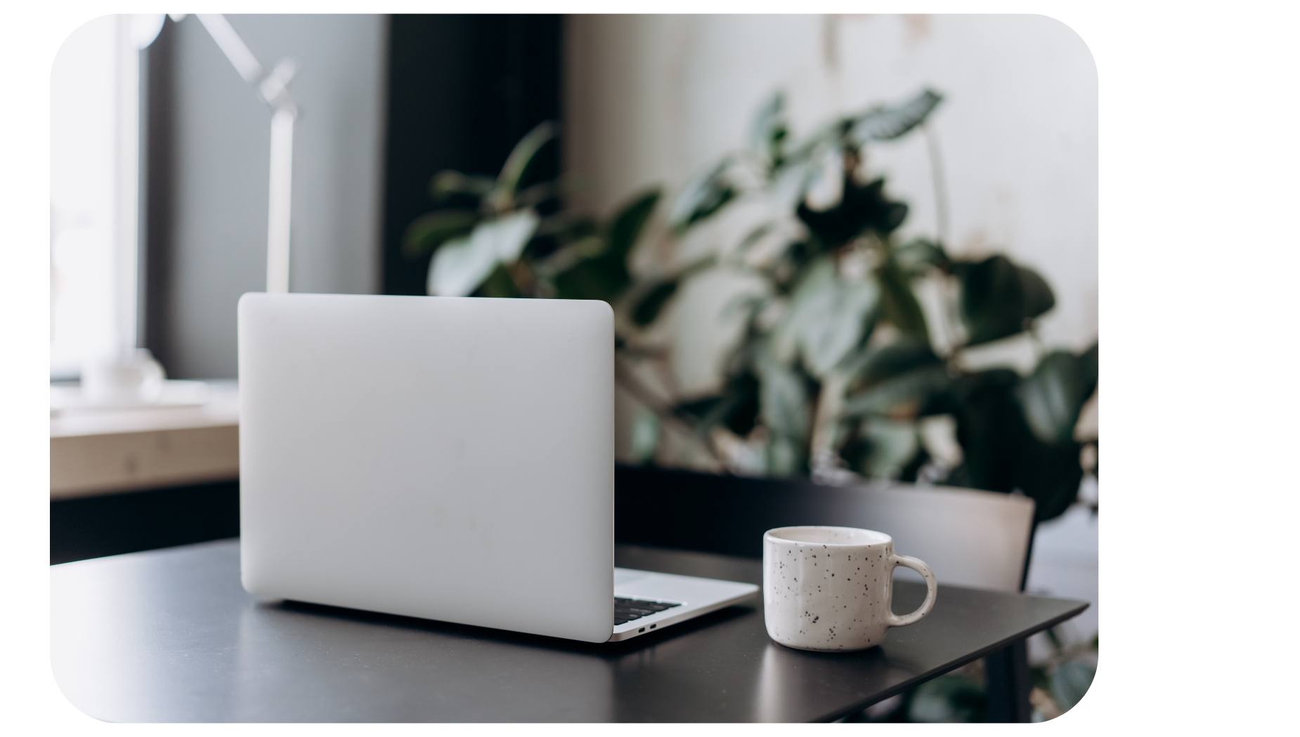 Laptop on desk with mug